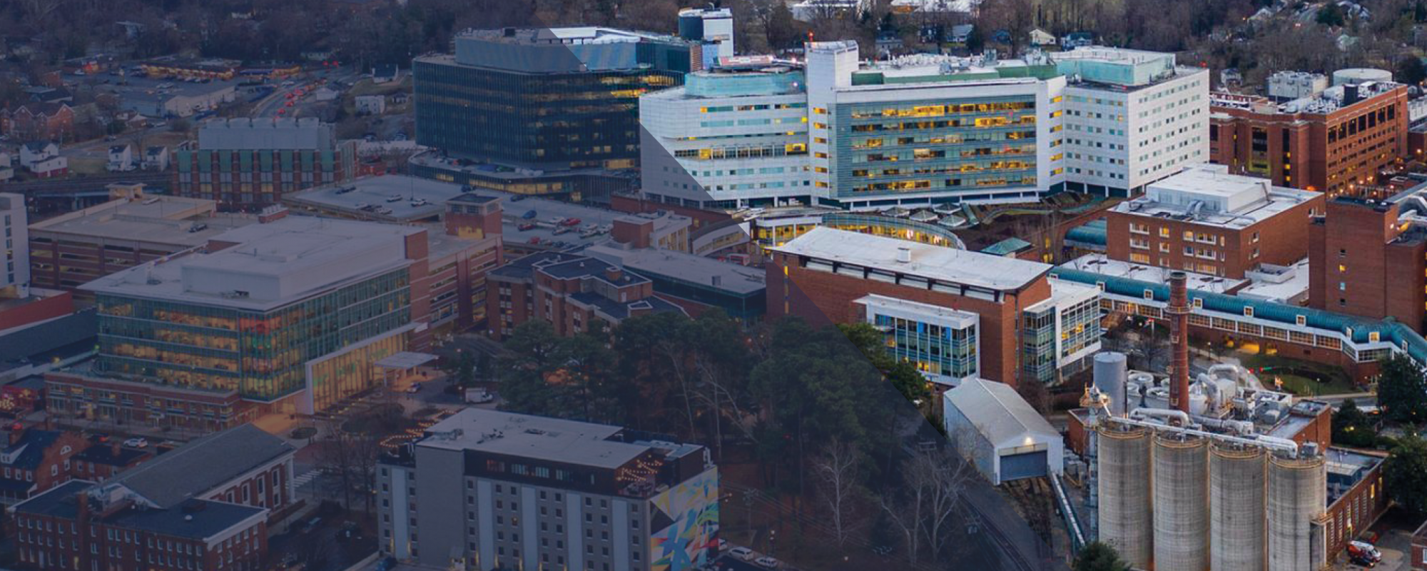 Aerial shot of UVA Health with a mountain sunset in the background.