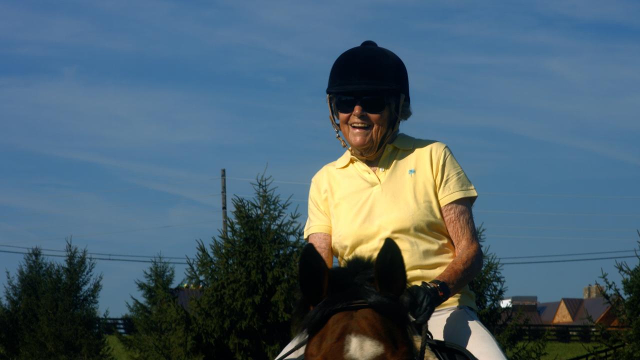 Carol Angle, age 90, a donor and grateful patient, rides her horse Tigger.