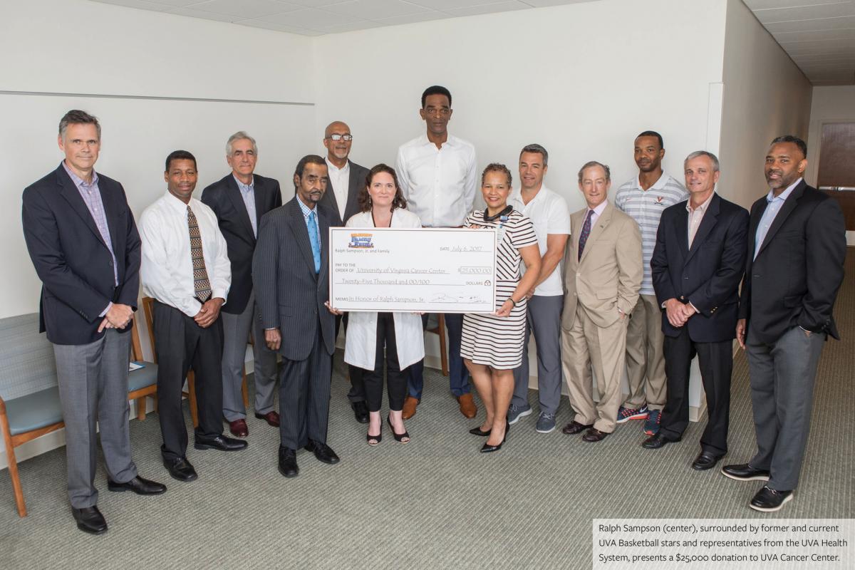 Ralph Sampson (center) surrounded by current and former UVA Basketball stars and representitives from the UVA Health System. 